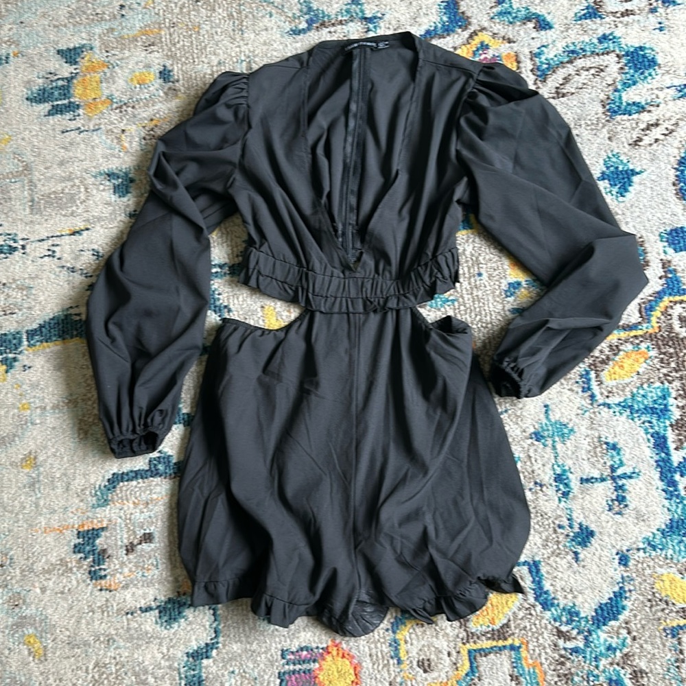Black cut out long sleeve romper.